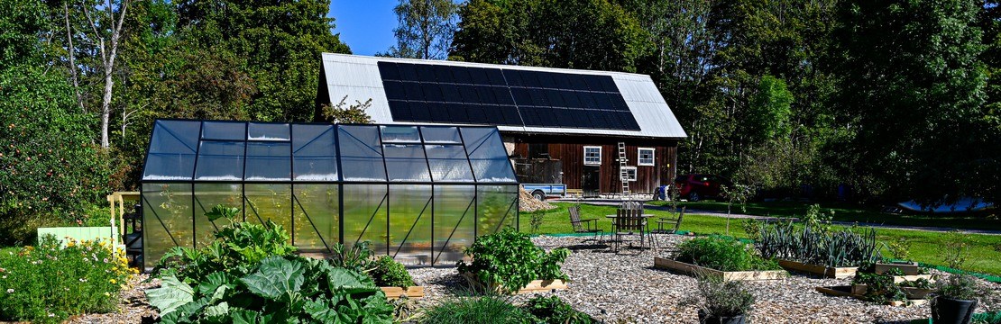 greenhouse and cultivating area infront of barn with solarpanels Hallabrottet Kumla Sweden september 4 2021