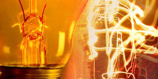 A lightbulb and swirls of light around it.
